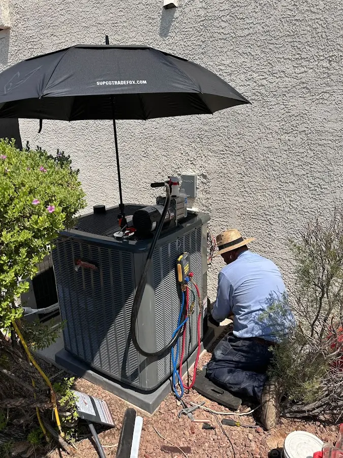 HVAC technician performing outdoor AC maintenance in South Euclid