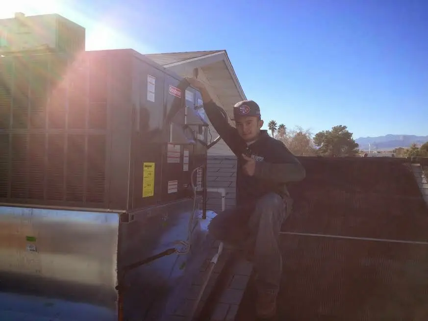 HVAC technician performing AC Tune-Up on a rooftop unit in South Euclid